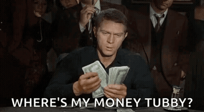 A Man Is Sitting At A Table Holding A Pile Of Money And Asking Where 'S My Money Tubby . GIF