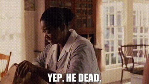 A Man Is Sitting At A Table In A Living Room And Talking To A Woman . GIF
