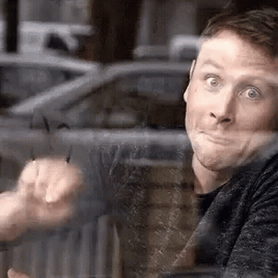 A Man Is Sitting At A Table Looking Out Of A Window . GIF