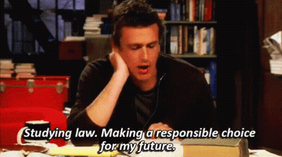 A Man Is Sitting At A Table With A Book And Says " Studying Law Making A Responsible Choice For My Future " . GIF