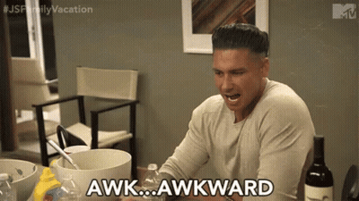 A Man Is Sitting At A Table With A Bottle Of Wine And Says Awkward . GIF