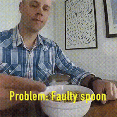 A Man Is Sitting At A Table With A Bowl Of Cereal And The Words Problem Faulty Spoon Behind Him GIF