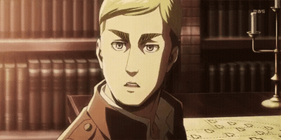 A Man Is Sitting At A Table With A Candle In Front Of A Bookshelf . GIF