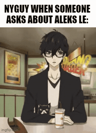 A Man Is Sitting At A Table With A Cup Of Coffee And A Cat On His Lap . GIF
