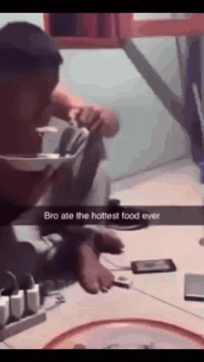 A Man Is Sitting At A Table With A Phone And A Bowl Of Food With The Caption Bro Ate The Hottest Food Ever GIF