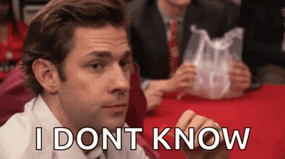 A Man Is Sitting At A Table With A Plastic Bag In His Hand And The Words `` I Don T Know '' Written On His Face GIF