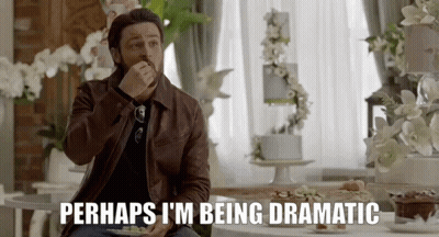 A Man Is Sitting At A Table With A Plate Of Food And The Words Perhaps I 'M Being Dramatic GIF