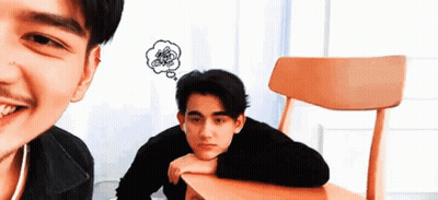 A Man Is Sitting At A Table With A Thought Bubble Above His Head . GIF