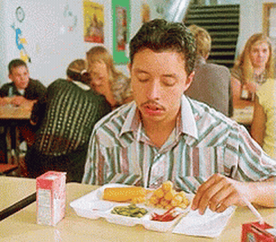 A Man Is Sitting At A Table With A Tray Of Food And A Carton Of Orange Juice GIF