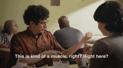 A Man Is Sitting At A Table With A Woman And Says " This Is Kind Of A Muscle Right ? Right Here " GIF