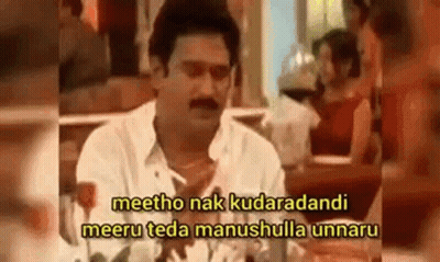 A Man Is Sitting At A Table With A Woman In A Restaurant And Talking To Her . GIF