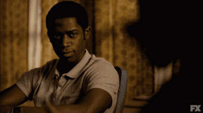 A Man Is Sitting At A Table With Fx Written On The Bottom GIF