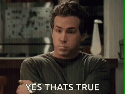 A Man Is Sitting At A Table With His Arms Crossed And The Words `` Yes That 'S True '' Written On The Screen . GIF