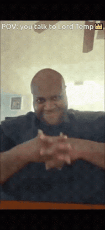 A Man Is Sitting At A Table With His Hands Folded In Front Of Him And A Caption That Says " You Talk To Lord Temp " GIF