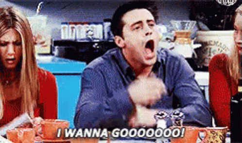 A Man Is Sitting At A Table With His Mouth Open And Saying I Wanna Goooooo ! GIF