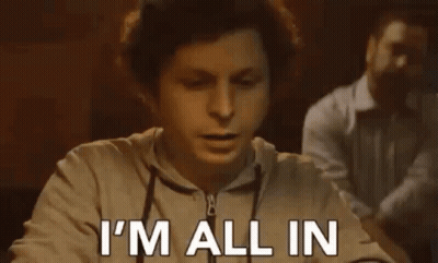 A Man Is Sitting At A Table With His Mouth Open And Says `` I 'M All In '' . GIF
