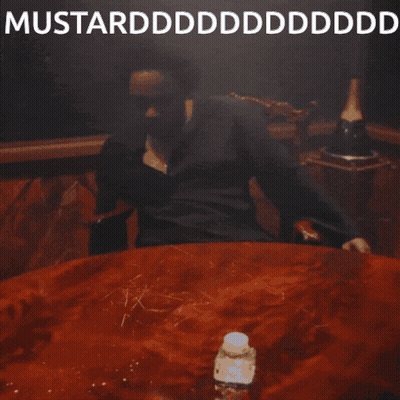 A Man Is Sitting At A Table With His Mouth Open And The Words Mustardddddddddddd On The Bottom GIF
