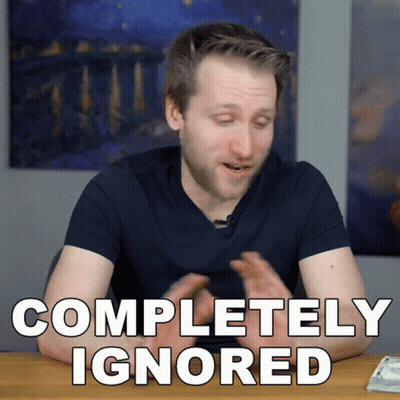 A Man Is Sitting At A Table With The Words Completely Ignored On The Screen GIF