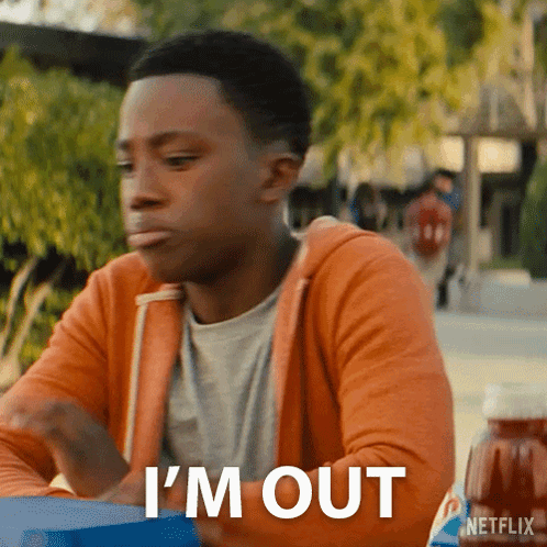 A Man Is Sitting At A Table With The Words I 'M Out On The Bottom GIF