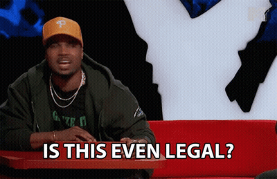 A Man Is Sitting At A Table With The Words Is This Even Legal GIF