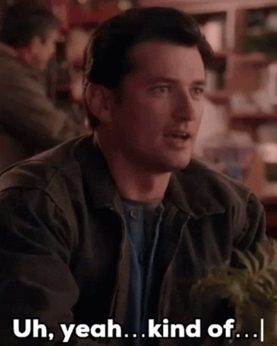 A Man Is Sitting At A Table With The Words Uh Yeah Kind Of GIF