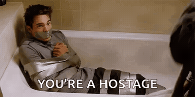 A Man Is Sitting In A Bathtub Wrapped In Duct Tape And Says `` You 'Re A Hostage '' . GIF