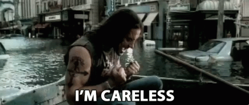 A Man Is Sitting In A Boat In The Water Smoking A Cigarette . GIF