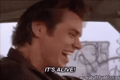 A Man Is Sitting In A Car And Saying `` It 'S Alive ! '' GIF