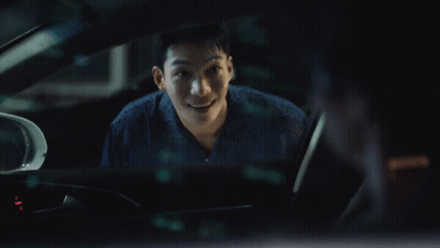A Man Is Sitting In A Car And Smiling GIF