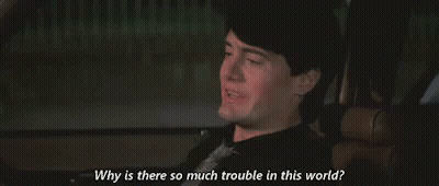 A Man Is Sitting In A Car And Talking To Someone . GIF