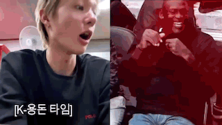 A Man Is Sitting In A Car Next To A Man In A Black Shirt . GIF