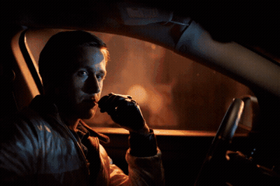 A Man Is Sitting In A Car With A Red Arrow Pointing To His Face GIF