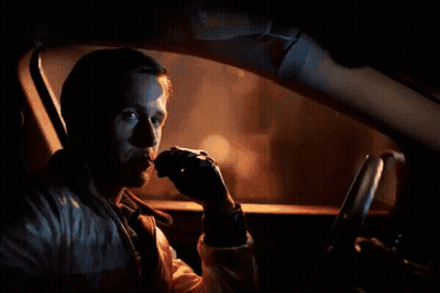 A Man Is Sitting In A Car With A Red Arrow Pointing To His Face GIF