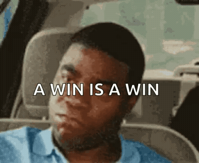 A Man Is Sitting In A Car With The Words A Win Is A Win Written Above Him . GIF