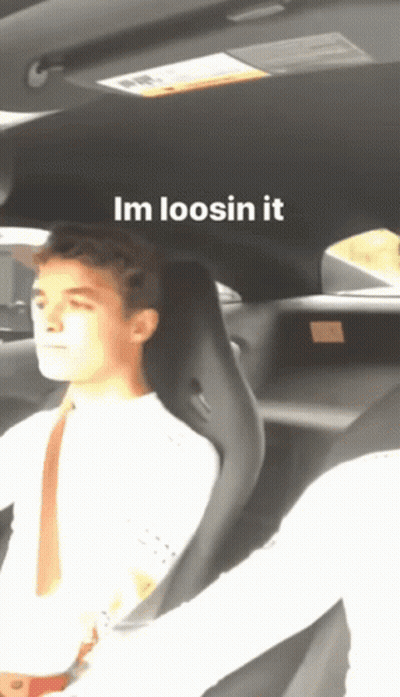 A Man Is Sitting In A Car With The Words Im Loosin It Written Above Him GIF