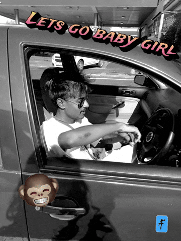 A Man Is Sitting In A Car With The Words Let 'S Go Baby Girl Written On The Side GIF