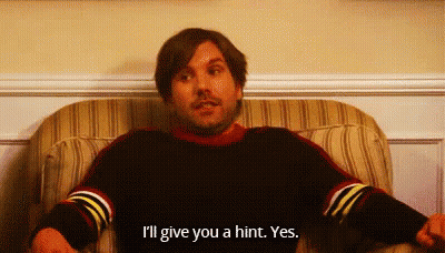 A Man Is Sitting In A Chair And Saying I 'Ll Give You A Hint Yes . GIF