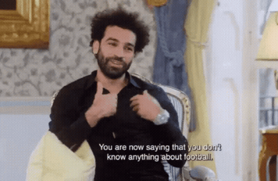 A Man Is Sitting In A Chair And Talking About Football GIF