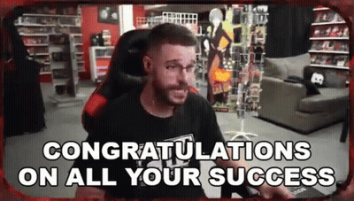 A Man Is Sitting In A Chair In A Room With The Words `` Congratulations On All Your Success '' . GIF