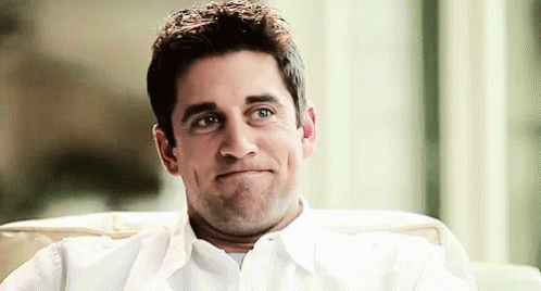 A Man Is Sitting In A Chair Making A Funny Face . GIF