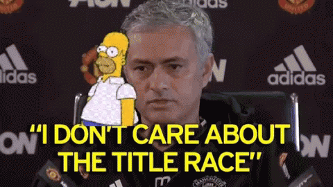 A Man Is Sitting In A Chair With A Cartoon Of Homer Simpson Behind Him . GIF