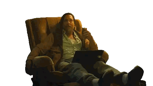 A Man Is Sitting In A Chair With A Laptop And A Welcome Home Sticker