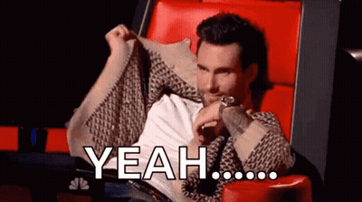 A Man Is Sitting In A Chair With His Arms Outstretched And Says Yeah GIF