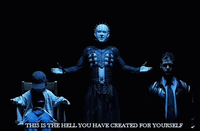 A Man Is Sitting In A Chair With His Arms Outstretched In Front Of A Man In A Suit And Tie . GIF