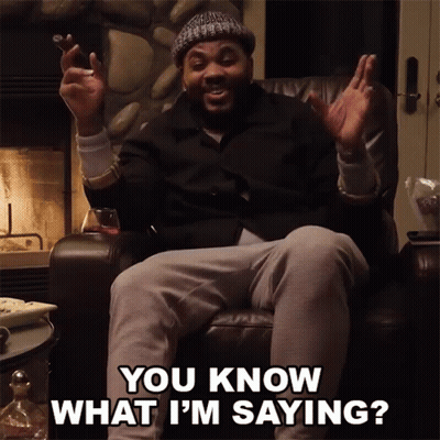 A Man Is Sitting In A Chair With His Hands In The Air And Says You Know What I 'M Saying GIF