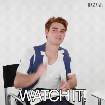 A Man Is Sitting In A Chair With His Hands In The Air And The Words `` Watch It '' Written Next To Him . GIF