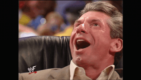A Man Is Sitting In A Chair With His Mouth Open And A W Logo On His Sleeve GIF