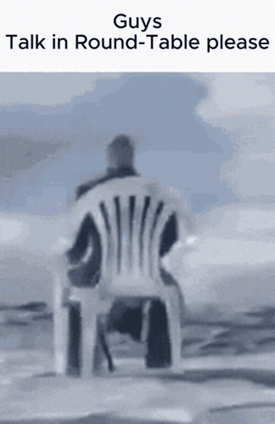 A Man Is Sitting In A Chair With The Words " Guys Talk In Round-Table Please " Above Him GIF