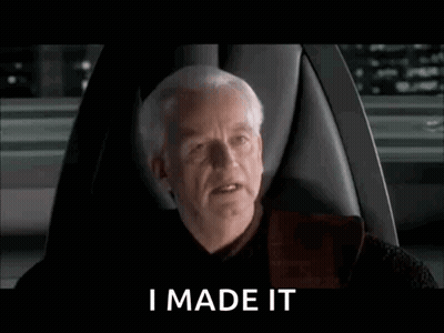A Man Is Sitting In A Chair With The Words `` I Made It '' Written On The Screen . GIF