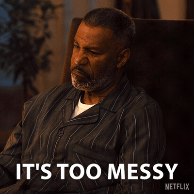 A Man Is Sitting In A Chair With The Words " It 'S Too Messy " Written Below Him GIF